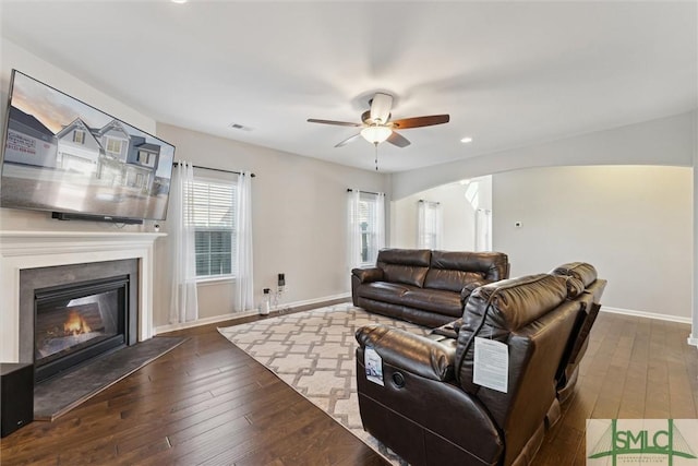 living room with ceiling fan and dark hardwood / wood-style floors