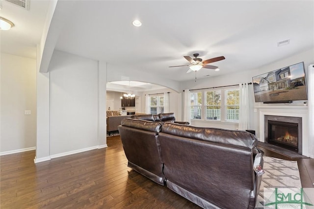 living room with dark hardwood / wood-style floors and ceiling fan with notable chandelier