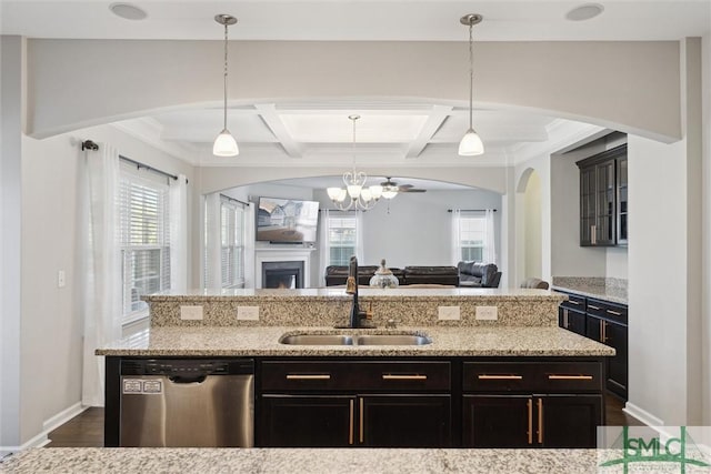 kitchen featuring sink, hanging light fixtures, light stone counters, coffered ceiling, and stainless steel dishwasher