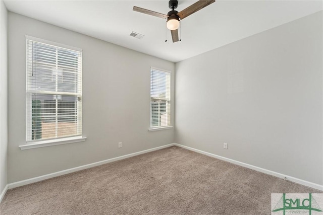 spare room with ceiling fan and carpet floors