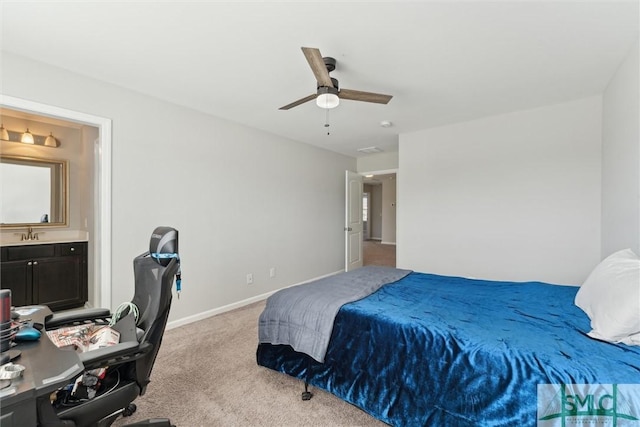 carpeted bedroom with ceiling fan and ensuite bath