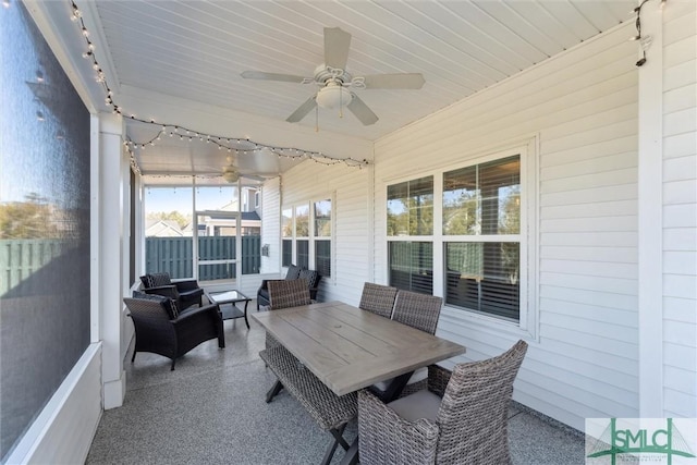 sunroom / solarium featuring track lighting and ceiling fan