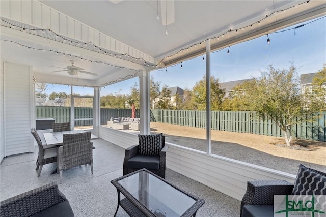 sunroom featuring ceiling fan