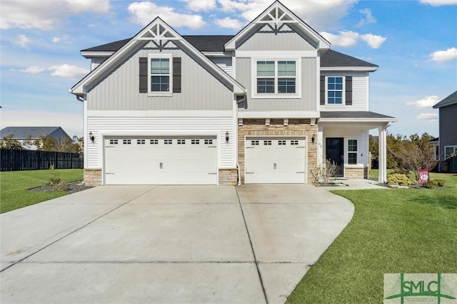 craftsman house with a garage and a front lawn