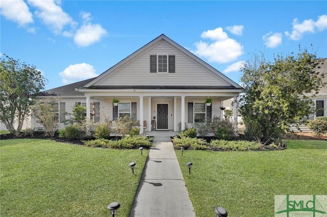 view of front of house featuring covered porch and a front yard