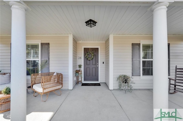 view of exterior entry with covered porch