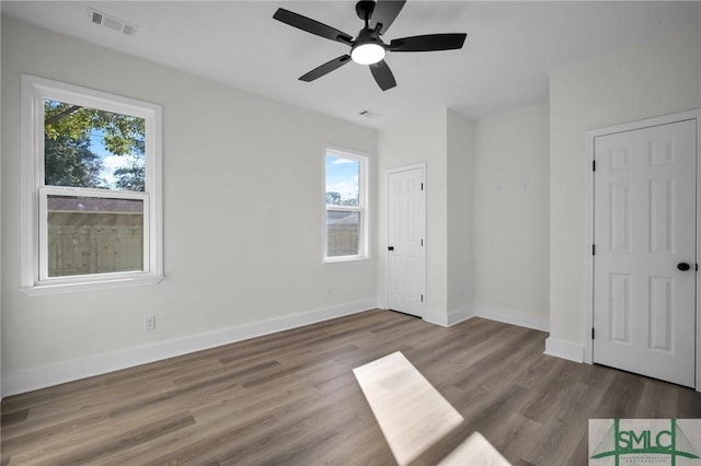 unfurnished bedroom with ceiling fan and light wood-type flooring