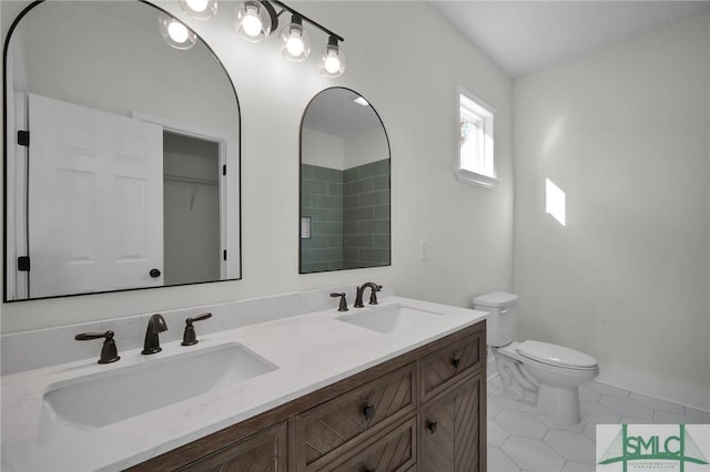 bathroom with tile patterned flooring, vanity, and toilet