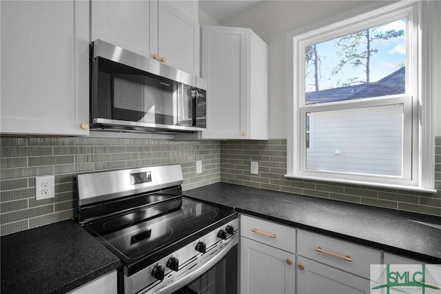 kitchen with white cabinetry, appliances with stainless steel finishes, and decorative backsplash