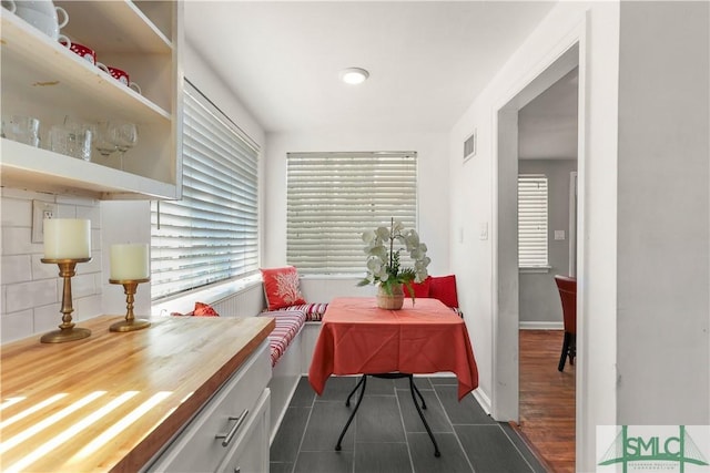 dining room featuring a wealth of natural light and dark hardwood / wood-style flooring