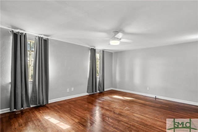 unfurnished room featuring hardwood / wood-style floors, a wealth of natural light, and ceiling fan