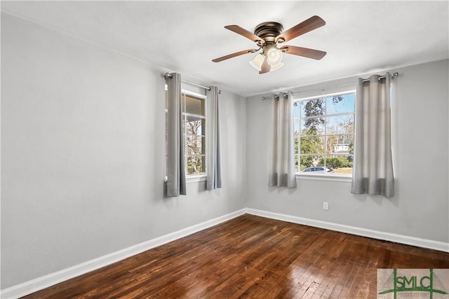 spare room featuring dark hardwood / wood-style floors and ceiling fan