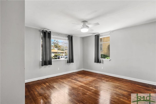 unfurnished room featuring dark hardwood / wood-style flooring and ceiling fan