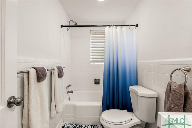 bathroom with toilet, tile walls, and shower / bath combo with shower curtain