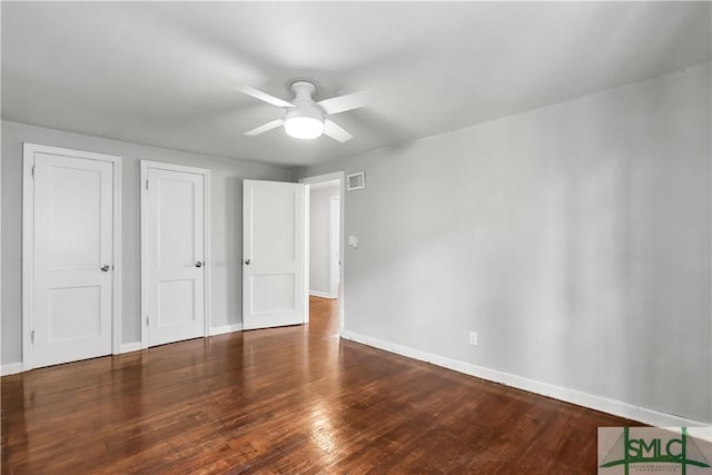 unfurnished bedroom featuring dark hardwood / wood-style flooring and ceiling fan