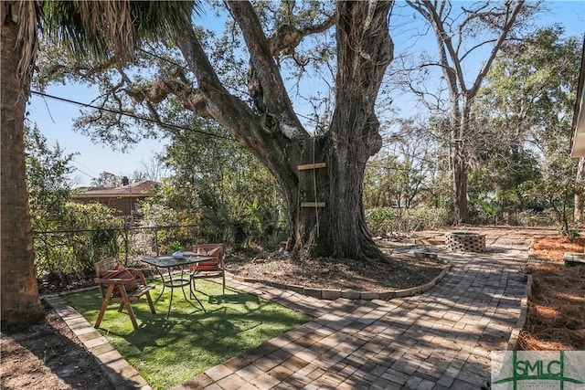 view of yard with a patio and a fire pit