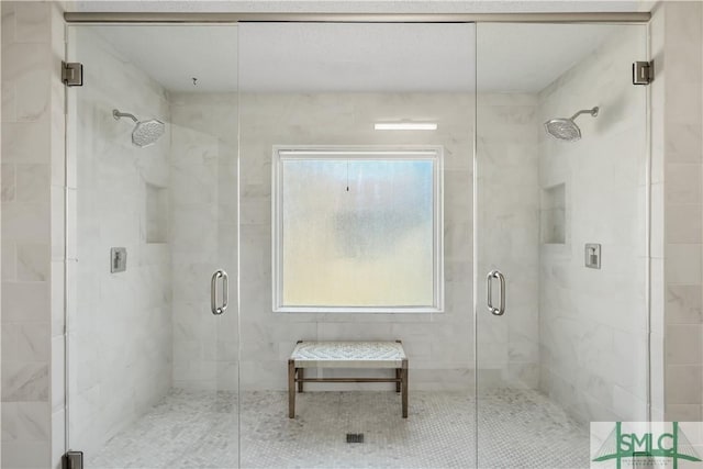 bathroom with a shower with door