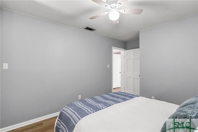 bedroom featuring dark wood-type flooring and ceiling fan