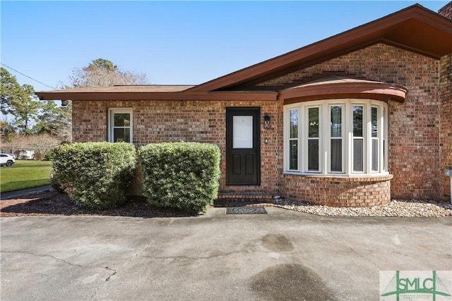 property entrance featuring a patio area