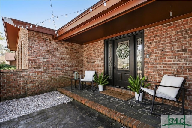 property entrance featuring a patio