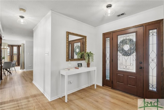 entrance foyer with crown molding and light hardwood / wood-style flooring