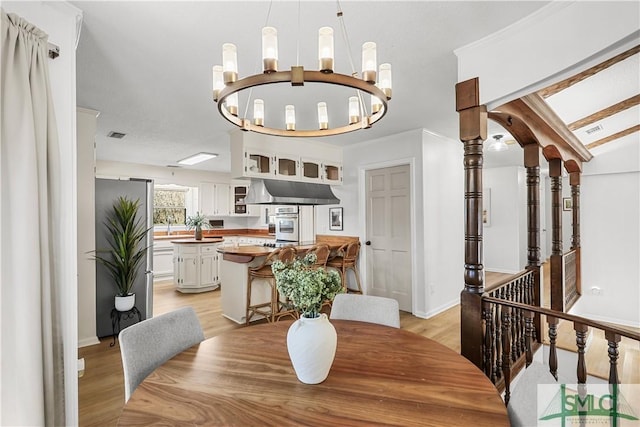 dining area featuring a notable chandelier and light wood-type flooring