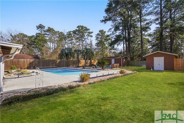 view of swimming pool with a yard and a storage unit