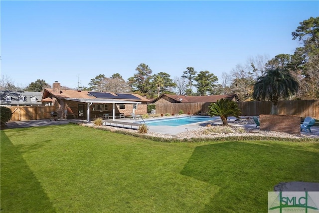 view of swimming pool featuring a yard and a patio area