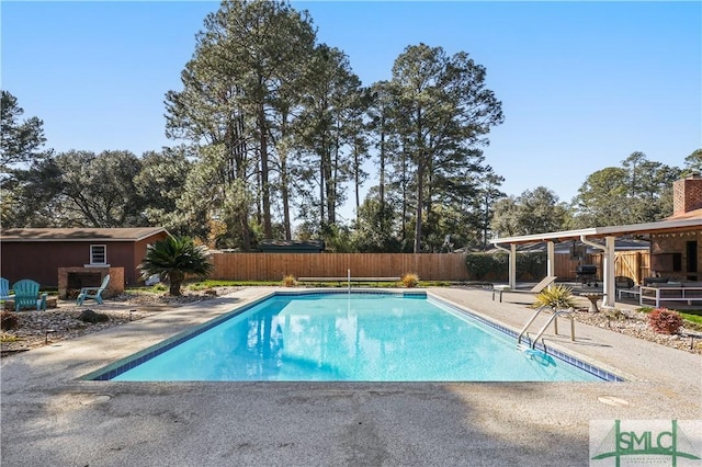 view of pool featuring an outdoor structure and a patio area