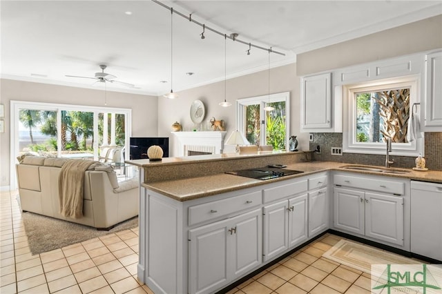 1 Bishopwood Ct, Savannah, GA 31411 - kitchen featuring white dishwasher, a sink, a peninsula, light tile patterned floors, and crown molding