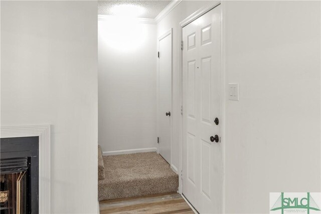 stairway with hardwood / wood-style floors and a textured ceiling