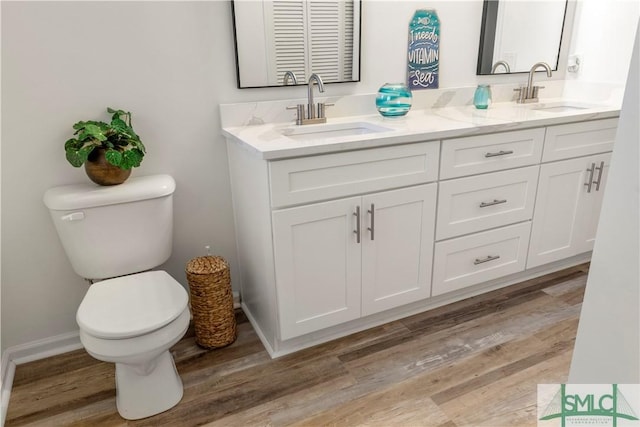 bathroom with hardwood / wood-style flooring, vanity, and toilet