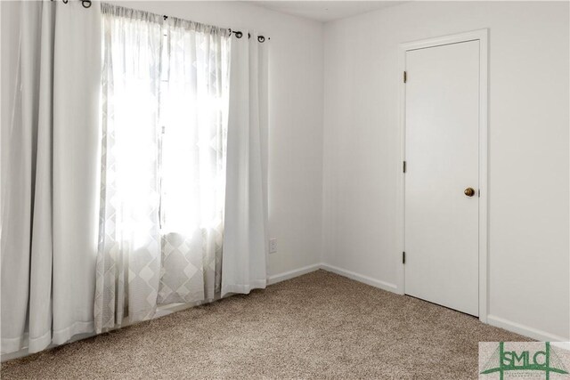 spare room with light colored carpet