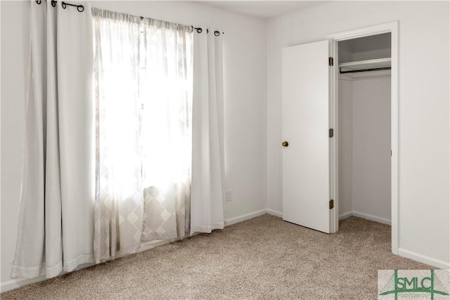 unfurnished bedroom featuring a closet and light carpet