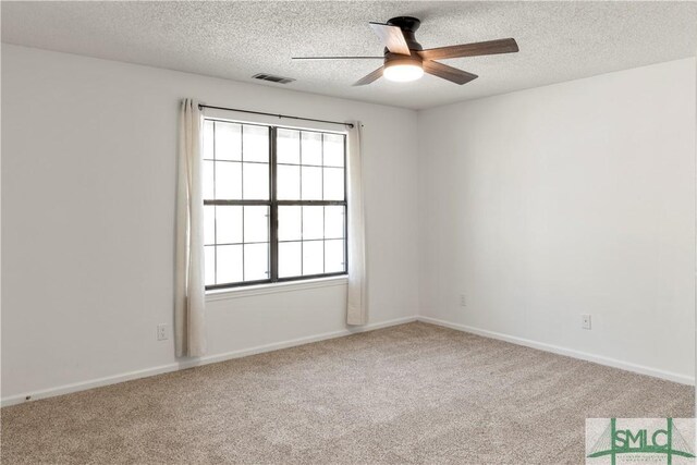 carpeted spare room featuring a textured ceiling and ceiling fan