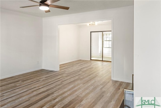 empty room featuring crown molding, ceiling fan, and light hardwood / wood-style floors