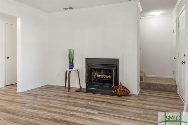 living room featuring crown molding and light wood-type flooring