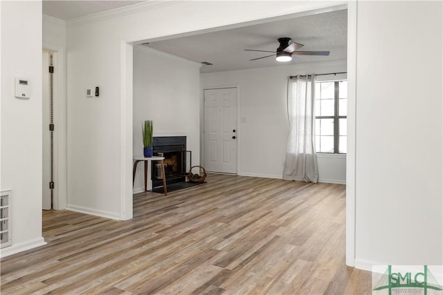 living room with crown molding, ceiling fan, and light hardwood / wood-style flooring