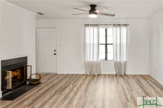 living room featuring ceiling fan, a textured ceiling, and light hardwood / wood-style floors