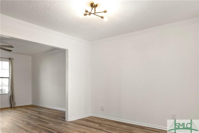 unfurnished room featuring crown molding, hardwood / wood-style flooring, and a textured ceiling