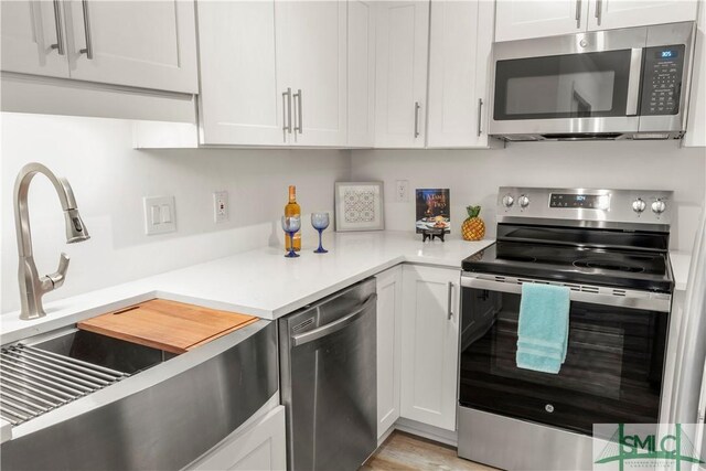 kitchen featuring white cabinetry, appliances with stainless steel finishes, and sink