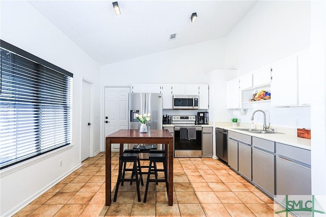 kitchen with white cabinetry, sink, gray cabinetry, light tile patterned floors, and stainless steel appliances