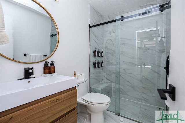 bathroom with walk in shower, vanity, toilet, and a textured ceiling