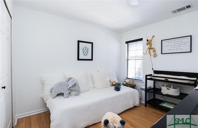 bedroom with wood-type flooring and a closet