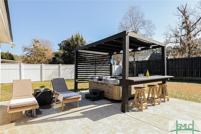 view of patio with a hot tub, an outdoor bar, and a pergola