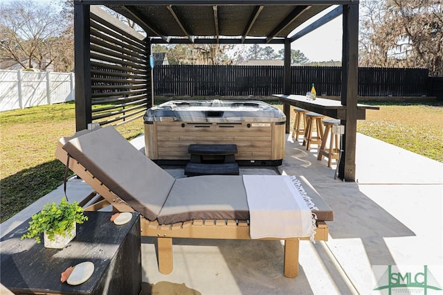 view of patio / terrace with a hot tub and an outdoor bar