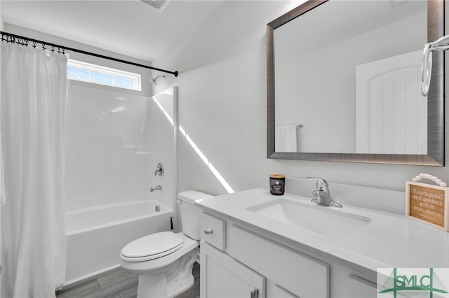 full bathroom featuring vanity, hardwood / wood-style floors, toilet, and shower / bath combo with shower curtain