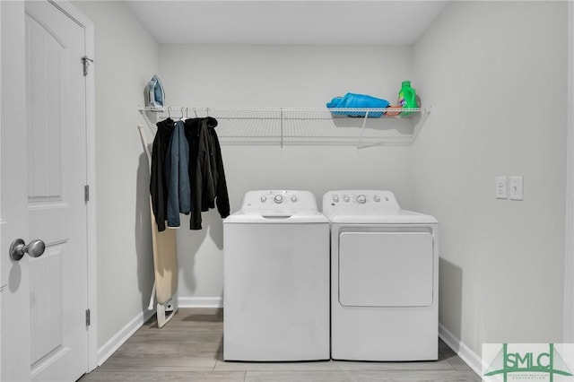 laundry area featuring wood-type flooring and washer and dryer