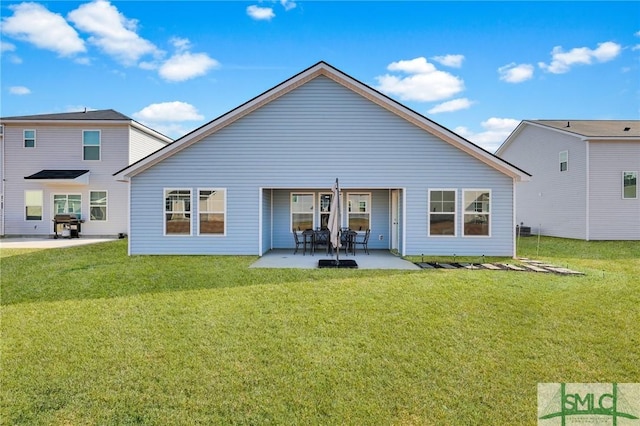 back of property featuring a yard and a patio area