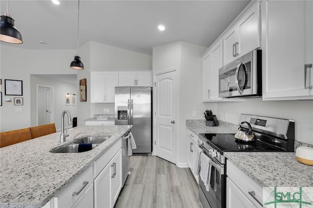 kitchen featuring white cabinetry, sink, decorative light fixtures, and stainless steel appliances